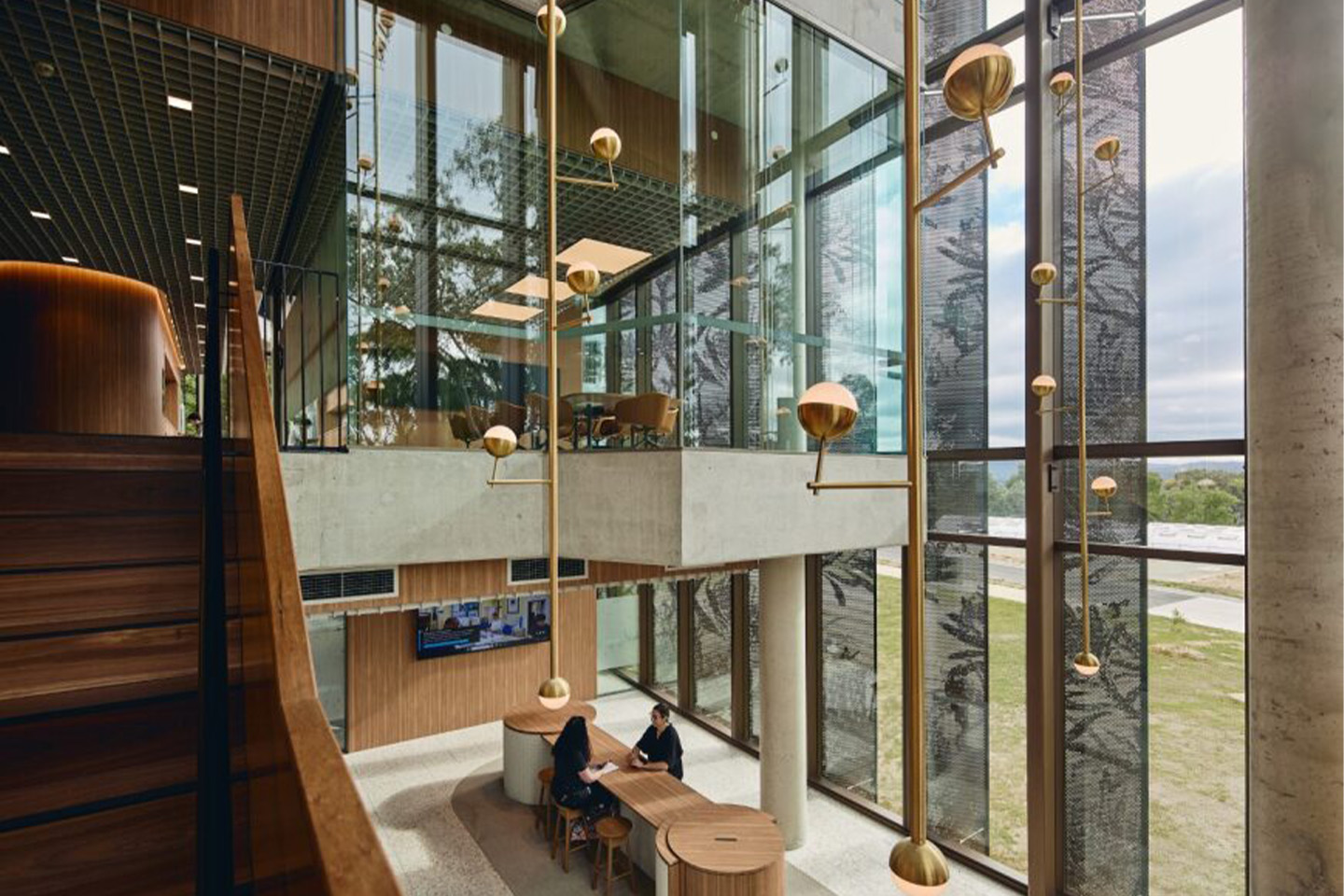 Image of the inside of a building, big floor to ceiling windows