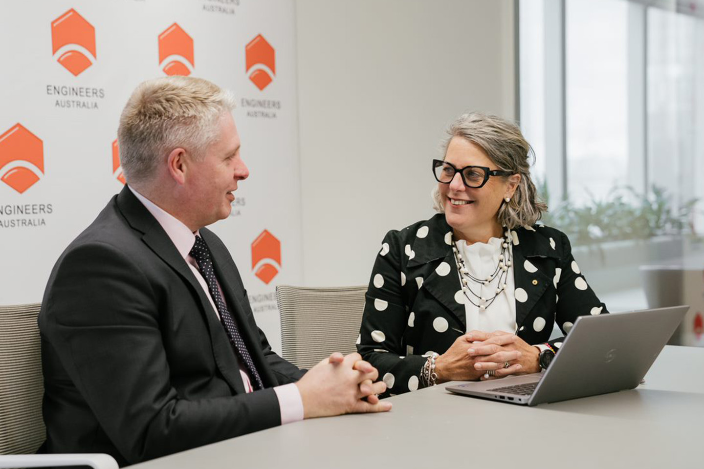 Romilly Madew and Nick Fleming talking at a table