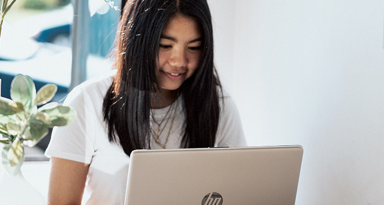 Young woman sitting with a laptop