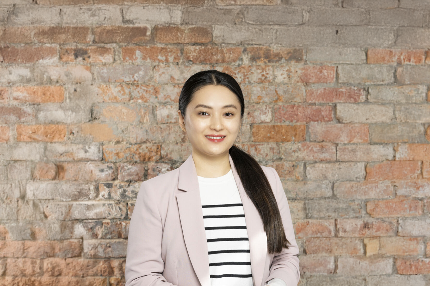 Image of Sonam Yangdon photographed against a brick wall